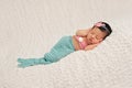 Sleeping Newborn Baby Girl in a Mermaid Costume