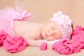 A sleeping newborn baby girl wearing a pink headband and tutu Royalty Free Stock Photo