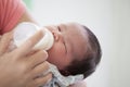 Sleeping newborn baby little girl drinking a milk from bottle Royalty Free Stock Photo
