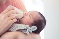 Sleeping newborn baby little girl drinking a milk from bottle Royalty Free Stock Photo