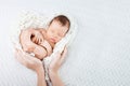 Sleeping newborn baby  in mother hands - hearth shape Royalty Free Stock Photo