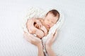 Sleeping newborn baby  in mother hands - hearth shape Royalty Free Stock Photo