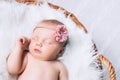 Sleeping newborn baby in a wrap on white blanket. Royalty Free Stock Photo
