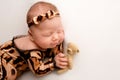 Sleeping newborn girl in the first days of life on a white background. Newborn baby in tiger pyjamas Royalty Free Stock Photo