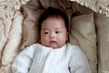 Sleeping newborn infant baby boy lying down on beautiful crib basket on bed, little cute child sleeping, lovely little kid yawning Royalty Free Stock Photo