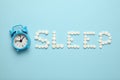 Sleeping pills and an alarm clock, insomnia concept. Nightmares and sleep disturbance Royalty Free Stock Photo