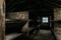 Sleeping quarters with wooden bunk beds showing prisoners terrible living conditions at The Nazi concentration camp of Royalty Free Stock Photo