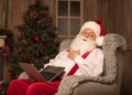 Sleeping Santa Claus with laptop Royalty Free Stock Photo