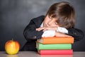 Sleeping school boy in classroom Royalty Free Stock Photo