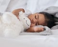 Sleeping, teddy bear and cute with baby in bedroom for relax, comfortable and dreaming. Innocence, young and rest with