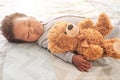 Sleeping, teddy bear and newborn with baby in bedroom for comfort, development and innocence. Dreaming, relax and