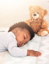 Sleeping, teddy bear and relax with baby in bedroom for carefree, development and innocence. Dreaming, cute and