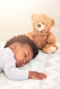 Sleeping, teddy bear and tired with baby in bedroom for carefree, development and innocence. Dreaming, relax and