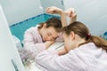 Sleeping teen girl with a toothbrush in hands