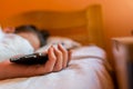 Sleeping teenage boy holding hes smartphone, conceptual image