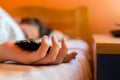 Sleeping teenage boy holding hes smartphone