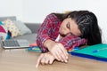 Sleeping teenage school girl at desk