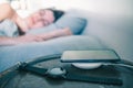 sleeping woman in bed cellphone charging on wireless charger