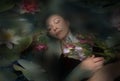 Sleeping woman in a dark water of a river Royalty Free Stock Photo