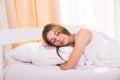 A sleeping woman is lying in bed with her head Royalty Free Stock Photo