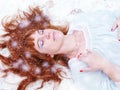 Sleeping woman in a snowy forest. sleeping Beauty. Fairytale image Royalty Free Stock Photo