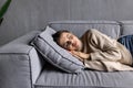 Sleeping young woman taking nap on the sofa during the day Royalty Free Stock Photo