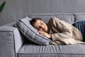 Sleeping young woman taking nap on the sofa during the day Royalty Free Stock Photo