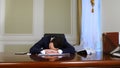 Sleeping young businessman awakened by phone call