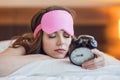 Sleeping young girl with a clock