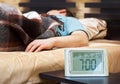 Sleeping young man with alarm clock Royalty Free Stock Photo