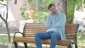 Sleeping Young Man Sitting Outdoor on Bench Royalty Free Stock Photo