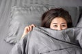 Sleepless Asian woman insomnia, overthinking lying down in bed late at night with dark eye circle Royalty Free Stock Photo