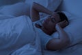 Sleepless Black Woman Lying In Bed And Touching Her Head Royalty Free Stock Photo