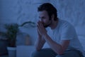 Sleepless guy sitting on bed at night, thinking about something Royalty Free Stock Photo