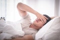 Sleepless hangover man on bed up with headache Royalty Free Stock Photo