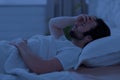 Sleepless man laying in bed alone at night Royalty Free Stock Photo