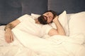 Sleepless night. Sleep disorders concept. Man bearded hipster having problems with sleep. Guy lying in bed try to relax
