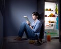 Sleepless woman reading in the kitchen