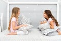 Sleepover party ideas. Girls happy best friends or siblings in cute stylish pajamas with pillows sleepover party Royalty Free Stock Photo