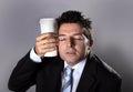 Sleepy addict businessman holding take away coffee in caffeine addiction Royalty Free Stock Photo