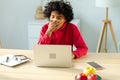 Sleepy african american woman sitting at table with laptop and yawning. Tired overworked girl lazy to work. Student Royalty Free Stock Photo