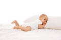 Sleepy baby. Cute, adorable little girl, toddler lying on bed on comfortable pillow against white background Royalty Free Stock Photo