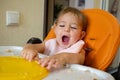 sleepy baby yawn after food in baby chair, child want to sleep Royalty Free Stock Photo