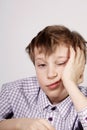 Blond cute schoolboy bored and tired after class (boredom) Royalty Free Stock Photo