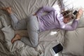 Sleepy caucasian girl with pillow and phone being lazy at the morning Royalty Free Stock Photo