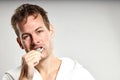 Sleepy caucasian guy brushing tooth wearing bathrobe, in the morning Royalty Free Stock Photo