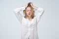 Sleepy or drowsy young girl wearing white shirt of her boyfriend, isolated on white. Royalty Free Stock Photo