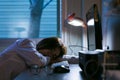 Sleepy exhausted woman working at office desk with her laptop. O