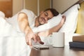 Sleepy guy waking up early after alarm clock signal Royalty Free Stock Photo