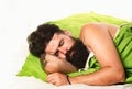 Sleepy and lazy person slowly posing alone. Man sleep in bed alone. Boy sleeping and dreaming. Joyful man sleeping on a Royalty Free Stock Photo